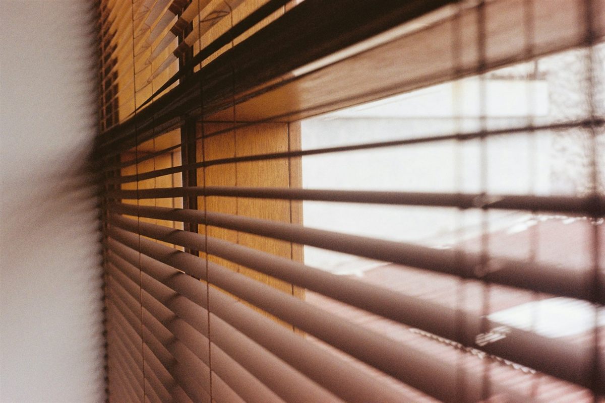 Close-up of wood blinds with daylight coming through the slats